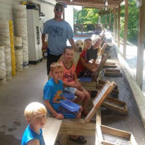 a whole family and their sweet dog flume mine at Gem Mountain