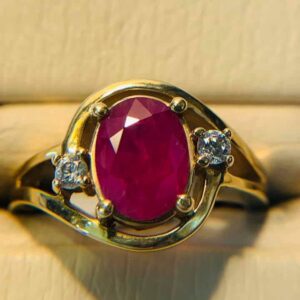 a stunning ring with a red stone set in the middle