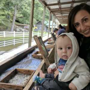 A mom and her toddler sift for gemstones at Gem Mountain
